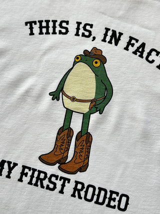 Frog wearing a cowboy hat and boots on a white shirt with text.